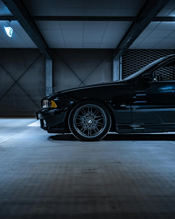 a very clean looking black car in a darkened place