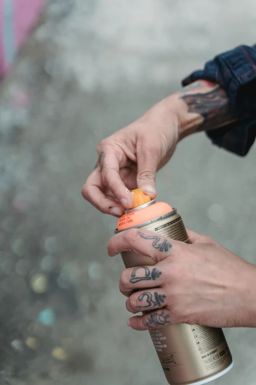 a man is handing out a drink from a can