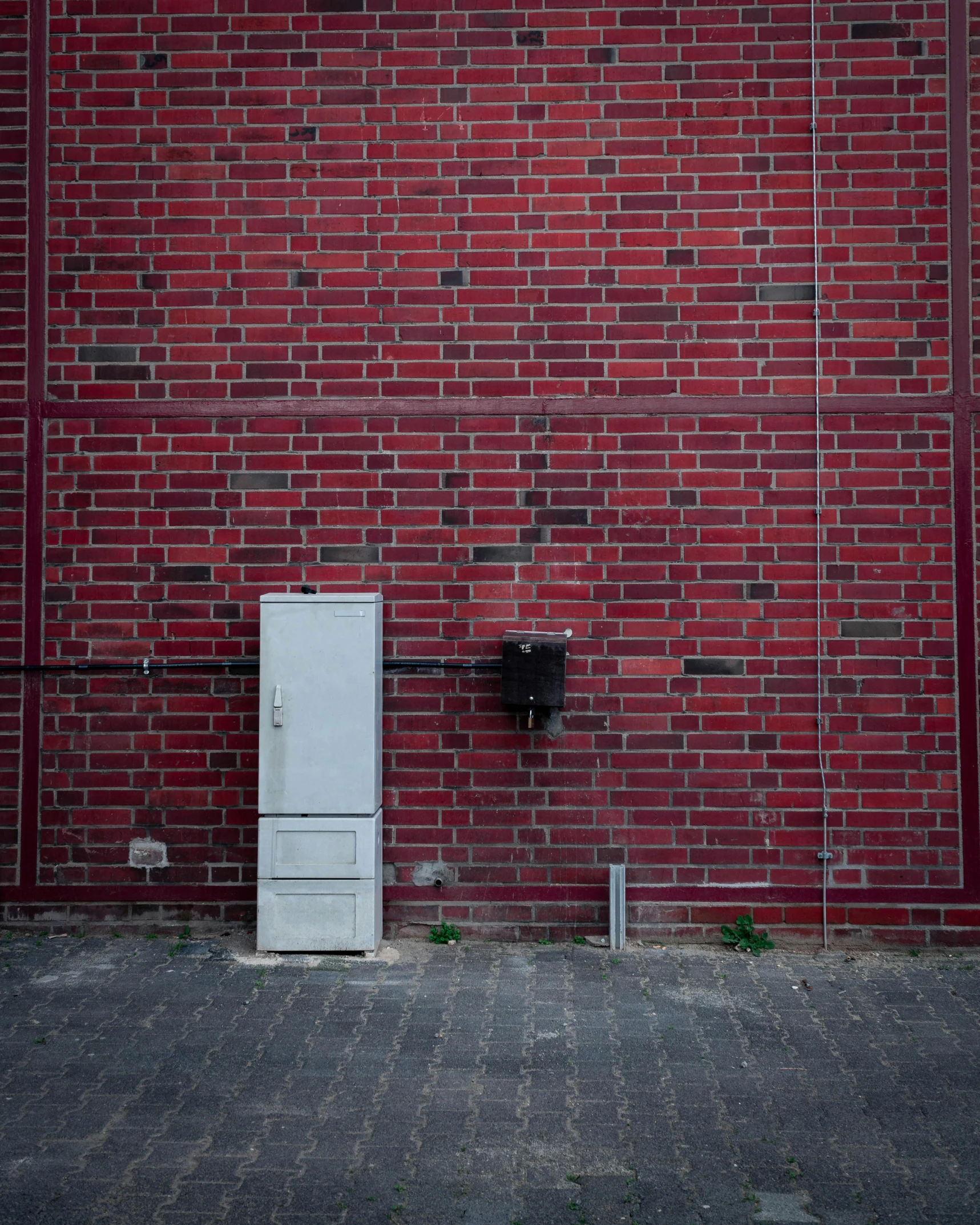 a red brick wall with an oven in front of it