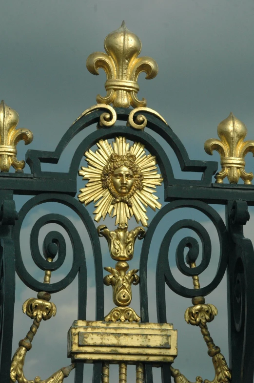 the golden sun is attached to the metal gate