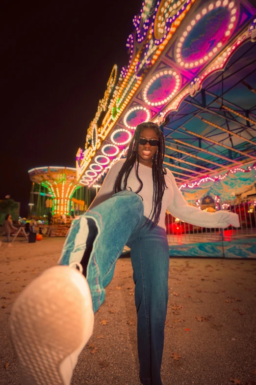 a man on a cell phone in front of a carnival