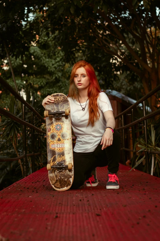  holding a skateboard in front of her