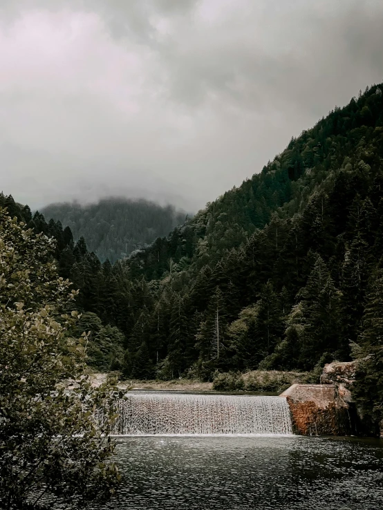 some sort of waterfall and trees in the background