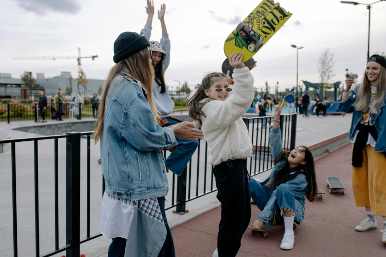 a group of young people stand and wave