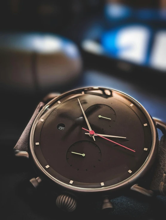 an analog watch sitting on top of a table