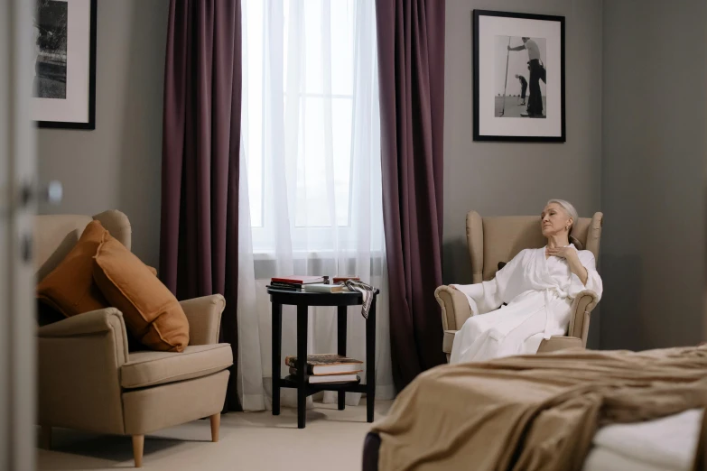 an older woman in a bedroom talking on the phone