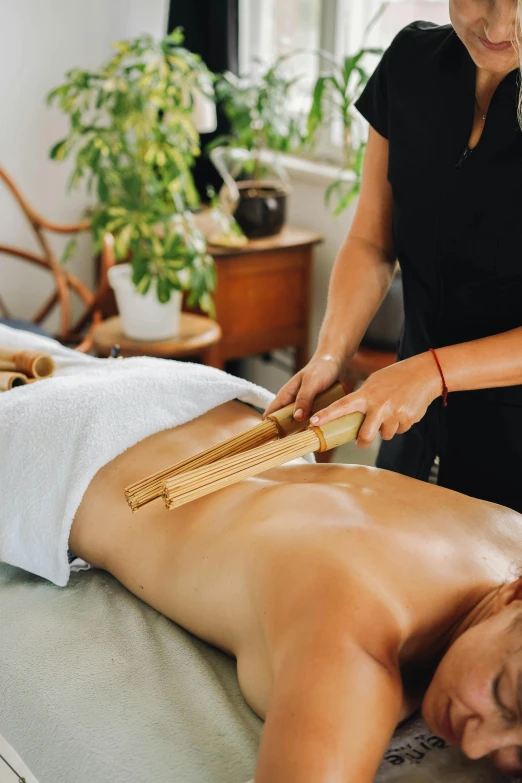 a woman getting a back massage from a man in a room