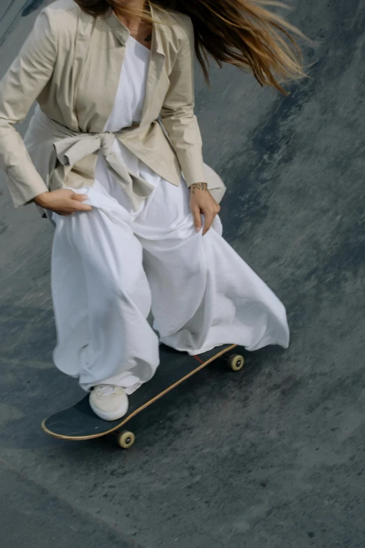 a female skateboarder is performing in the air