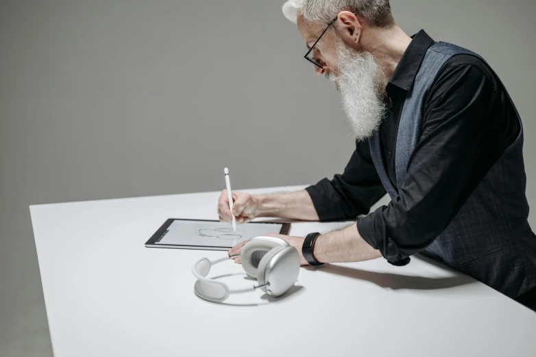 an old man is taking notes on his desk