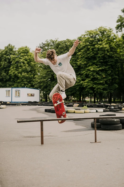 a boy is skateboarding over an object on a rail