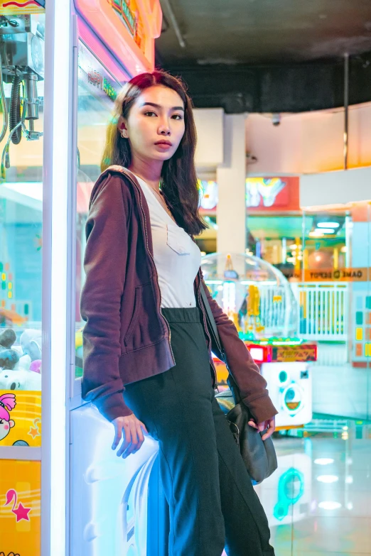 a woman is leaning on a window display in a store