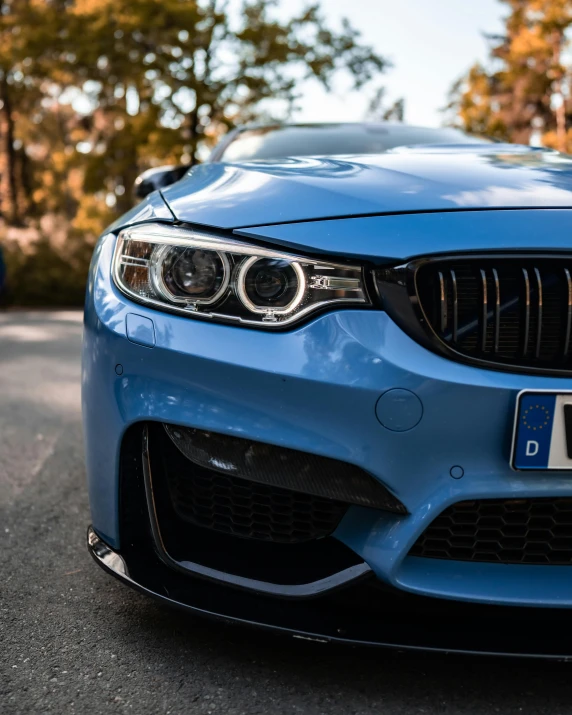 a blue sports car is shown on a street