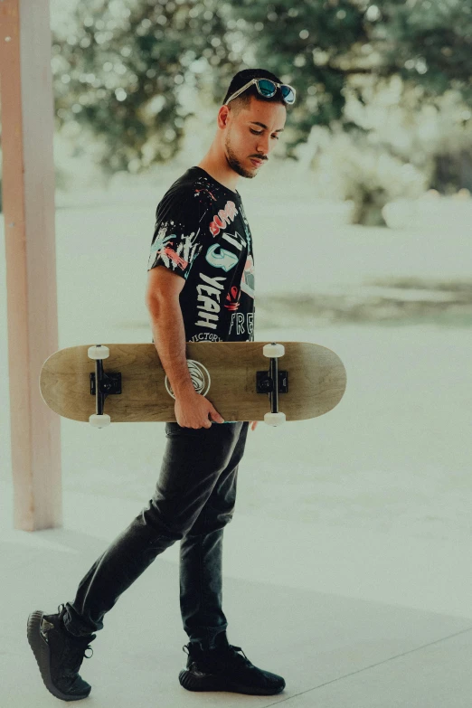 a man holding a skateboard in his left hand