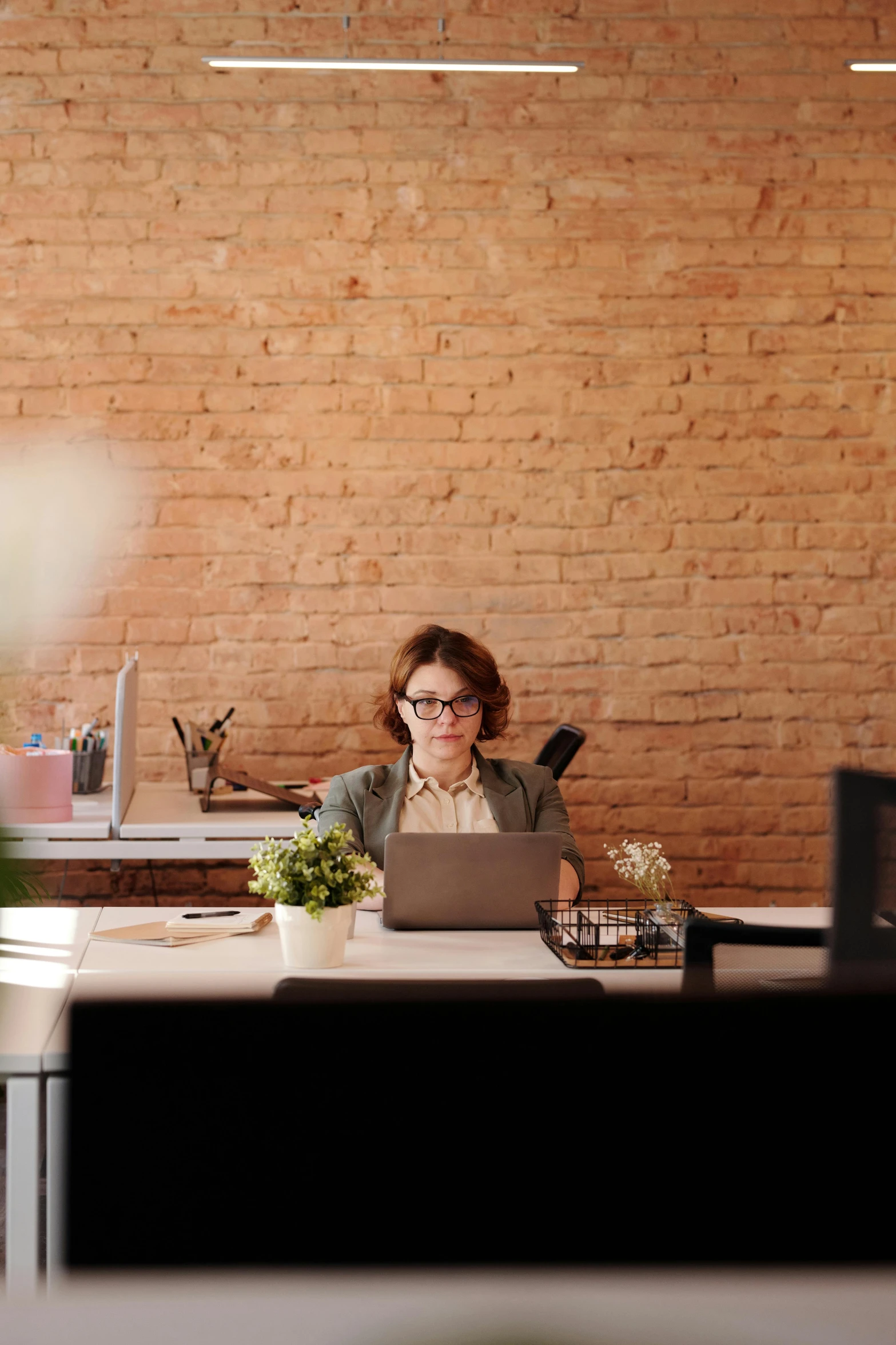 a woman on her computer sitting in a chair