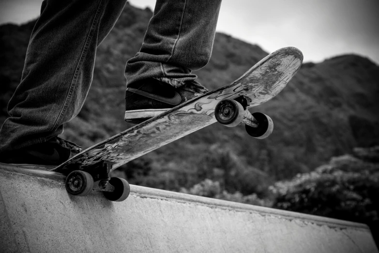 a skate boarder riding the edge of a half pipe