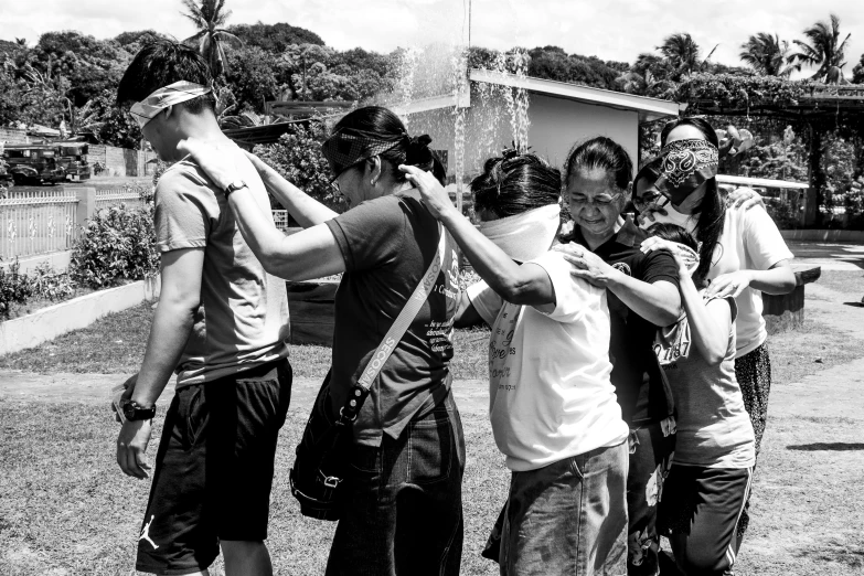 there is a group of people standing together and holding hands