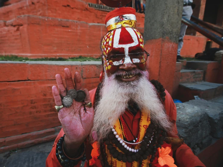 man dressed in traditional costume standing outside with his hand out