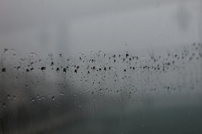 rain drops on a glass and a view of city buildings through window