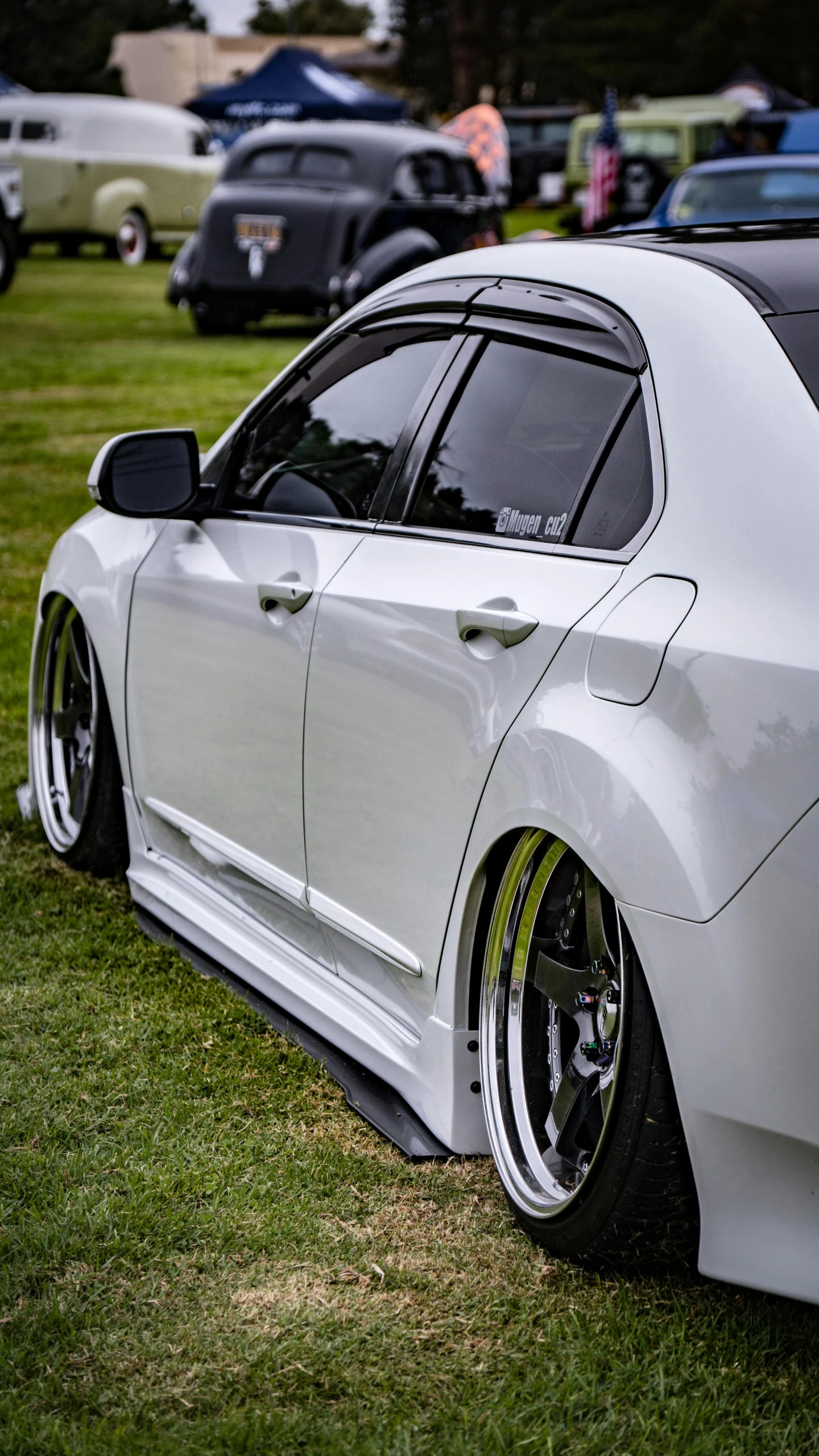 a close up of the tail end of a white car