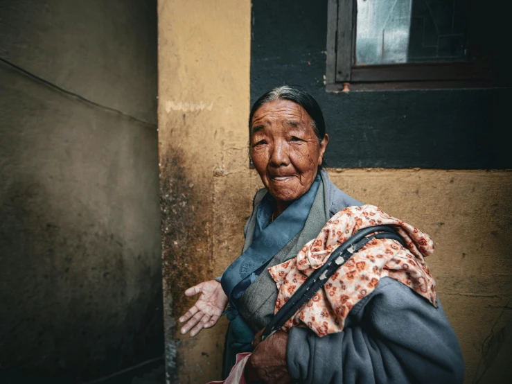 an older woman is holding soing on her hand