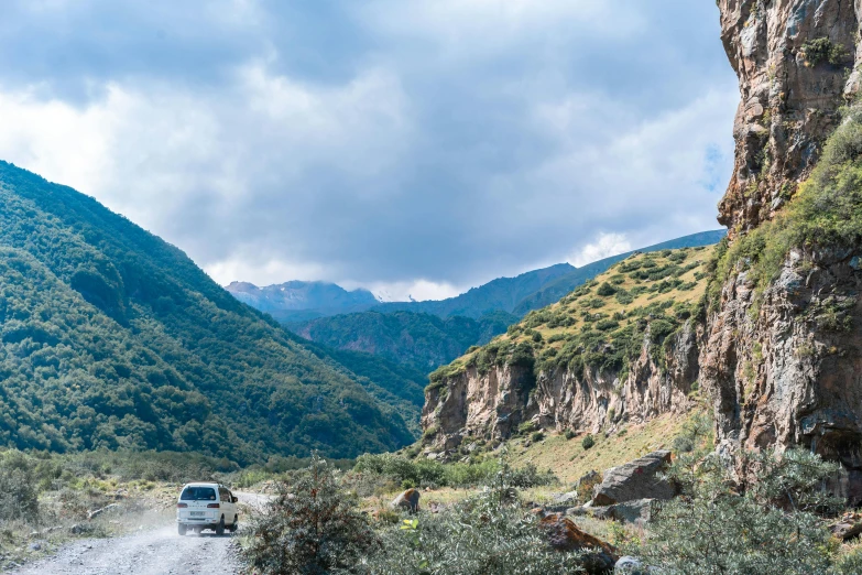 the vehicle is driving down the mountain road