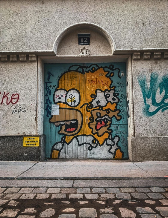 graffiti on the door of an office building that has an image of homer on it
