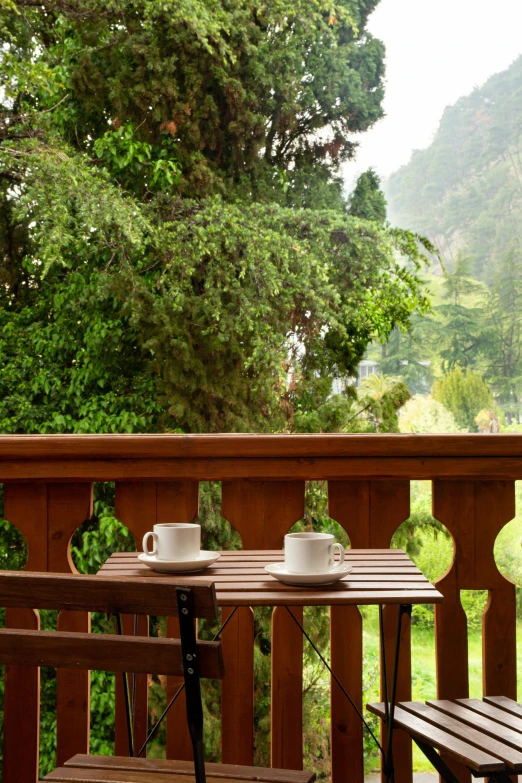 the outside balcony has two benches and two cups