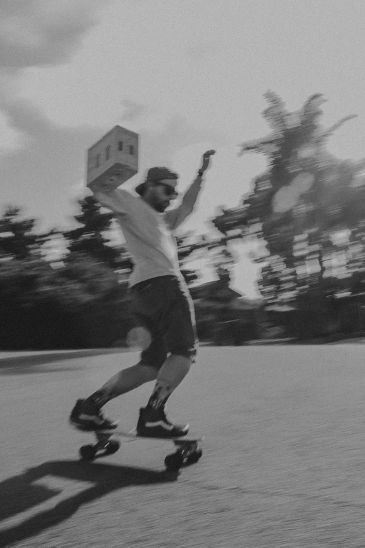 a man is skateboarding with a box on his head