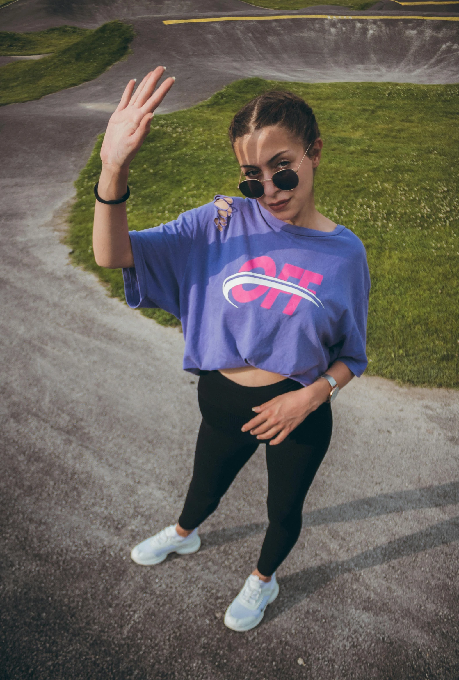 a female wearing a blue crop top and sunglasses, dancing