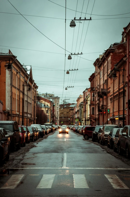 cars parked on a street in front of row houses