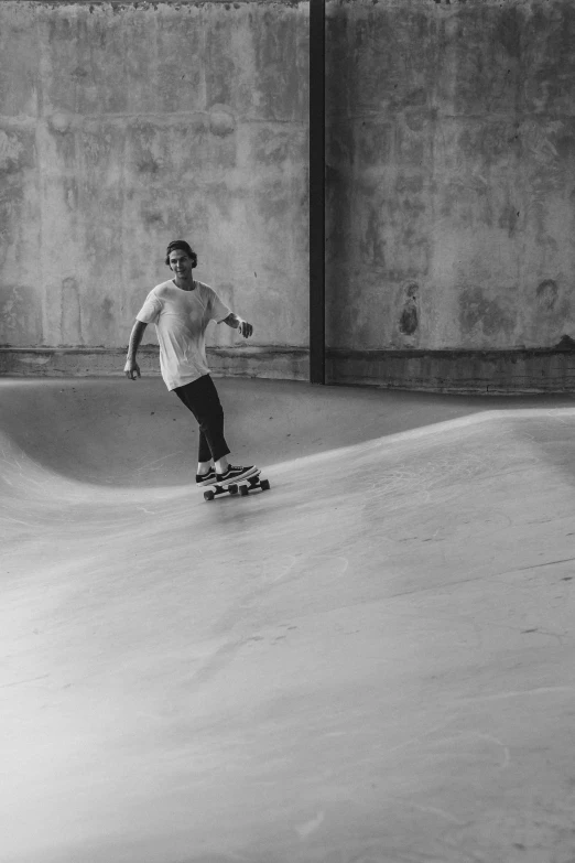 a person riding a skate board in a concrete bowl