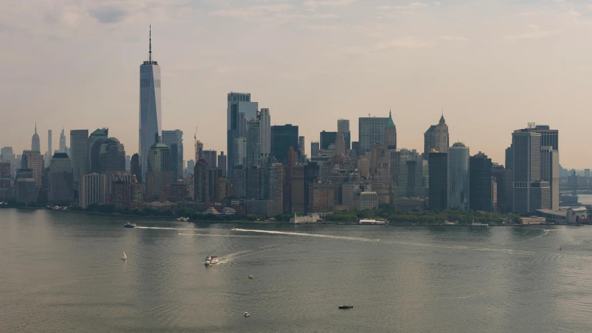 a large city has a boat moving along the water