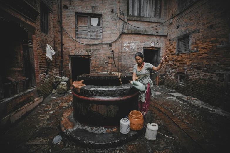 a person next to a huge brick building