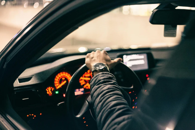 a man is holding the wheel stick in a vehicle