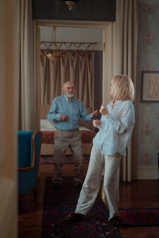 an older couple standing in the doorway talking