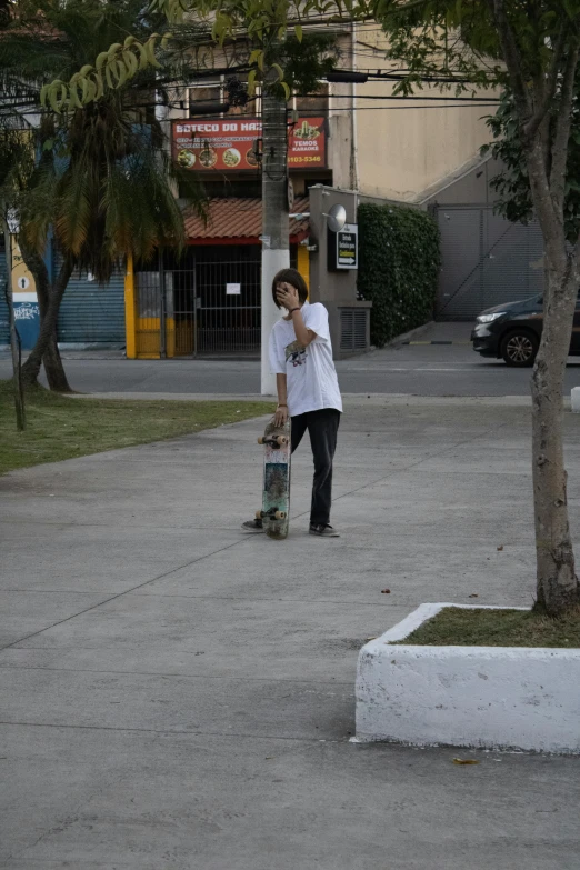 a boy skateboarding on his board on the street