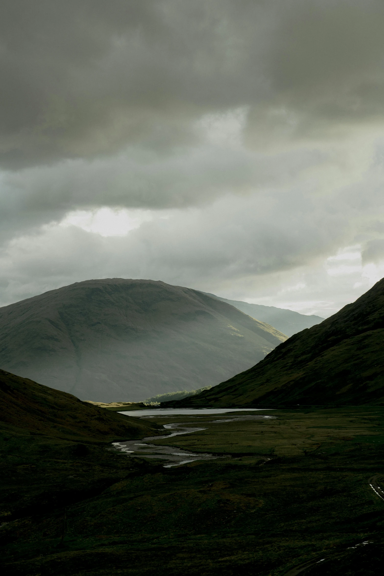 dark clouds move over a valley in the distance