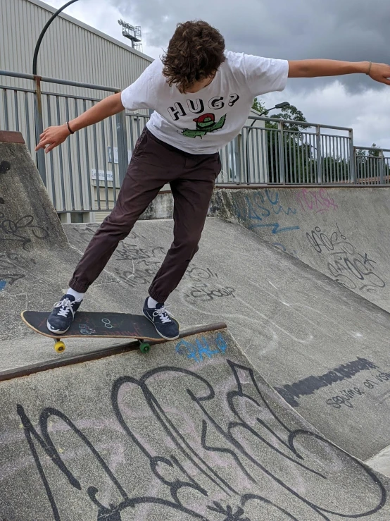 the skateboarder is about to perform on the ramp