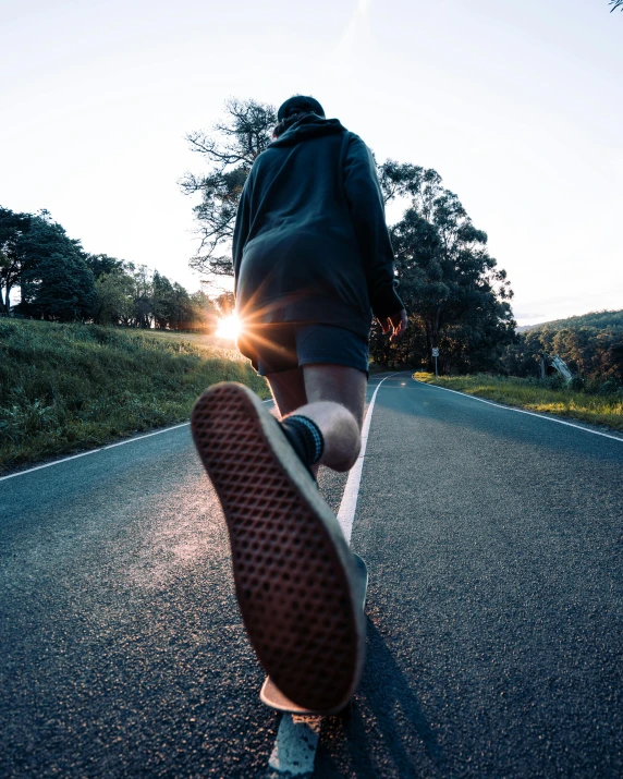 a person riding a skateboard down the middle of a road