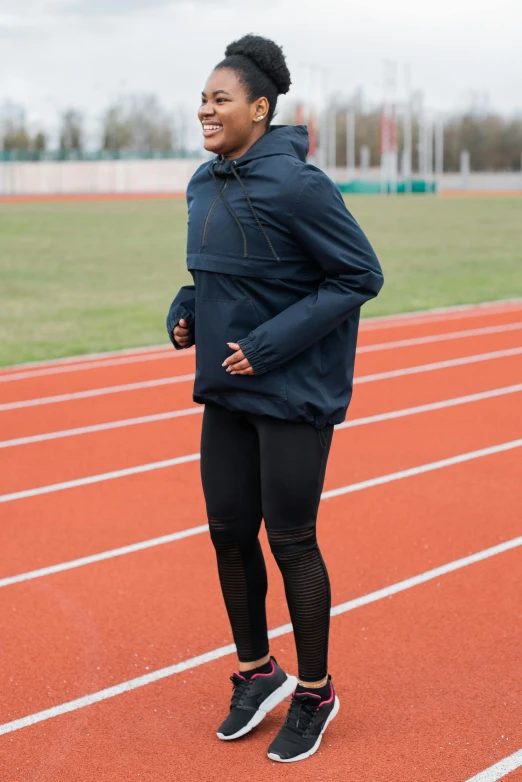 a woman standing on top of a race track