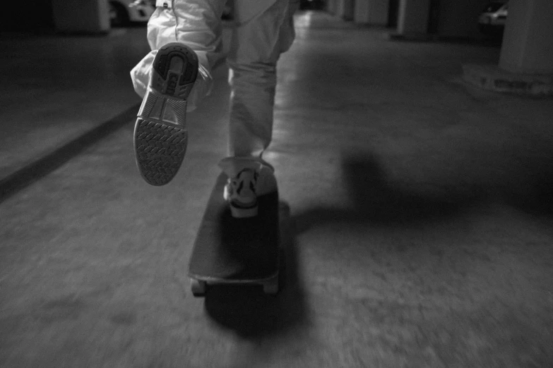 a boy is balancing his skateboard on the sidewalk