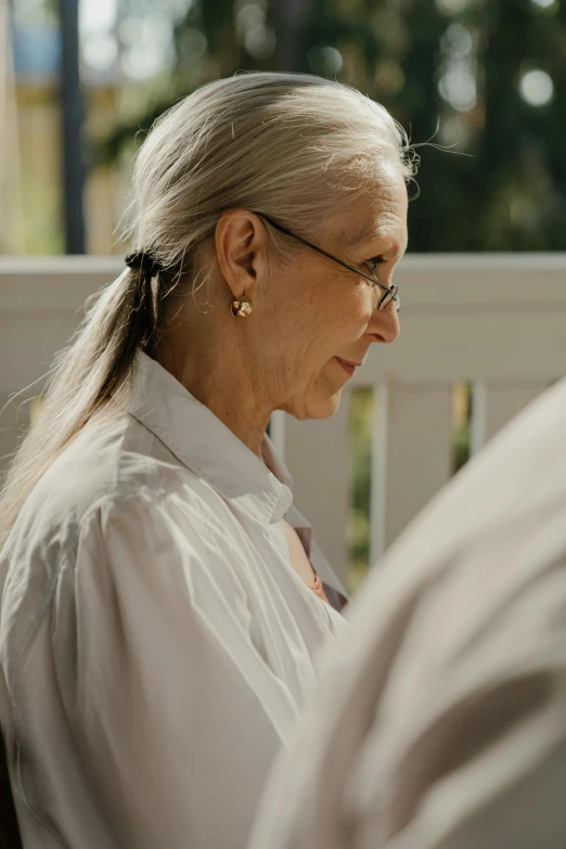 a woman wearing glasses on top of a white deck