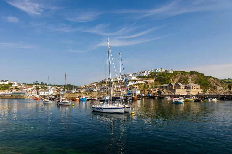 boats are docked in the harbor with an island behind them