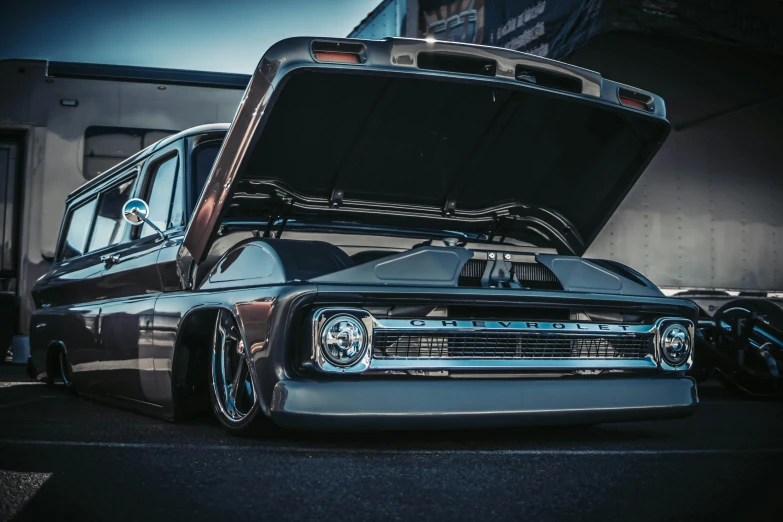 an automobile with a large open hood sits parked