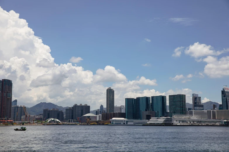 the cityscape looks very large and blue with clouds