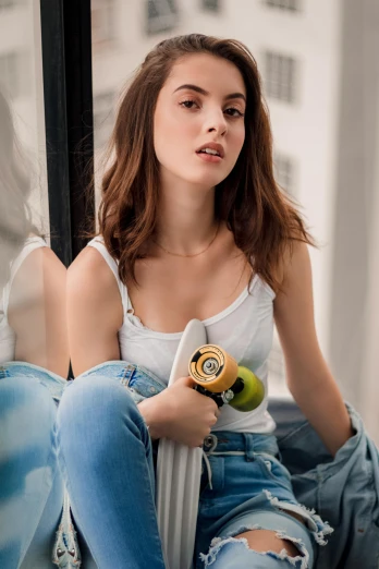 a woman sitting on a ledge with a hair dryer in her hand