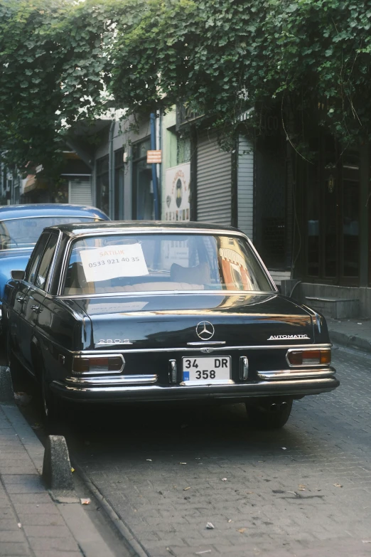 a car on a city street has an image of a person in the back