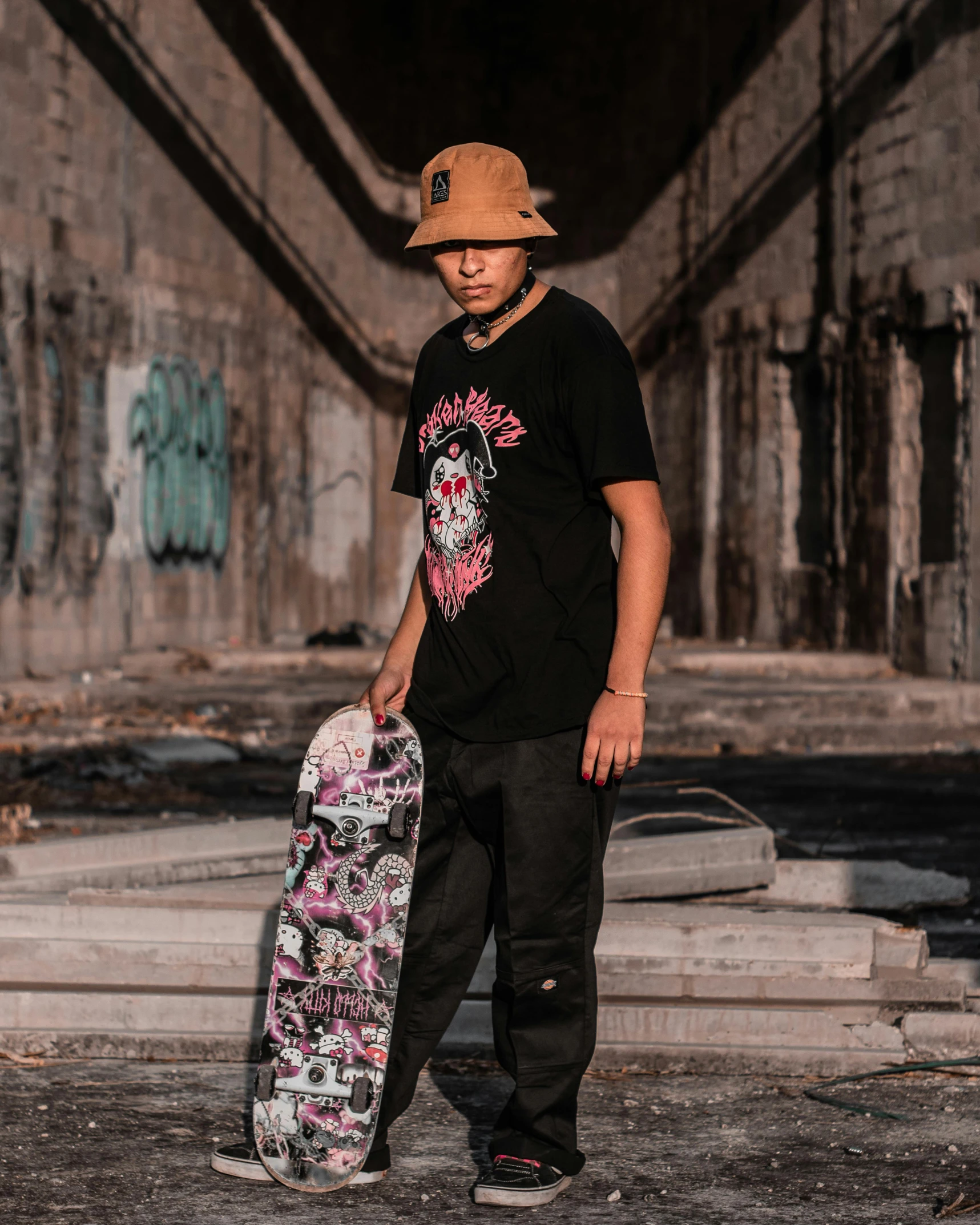 a man wearing a hat holding a skateboard