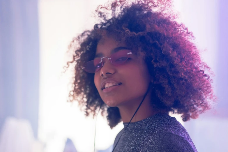 a close - up of a young lady wearing glasses and a black shirt