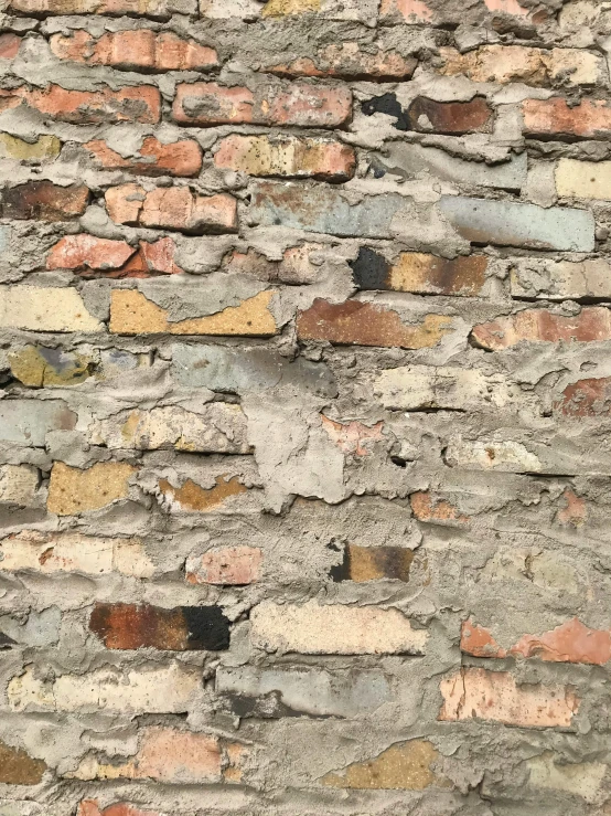 a brick wall that is painted red yellow blue and brown